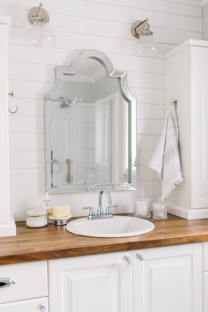 A small master bath maximizes storage using vertical towers.