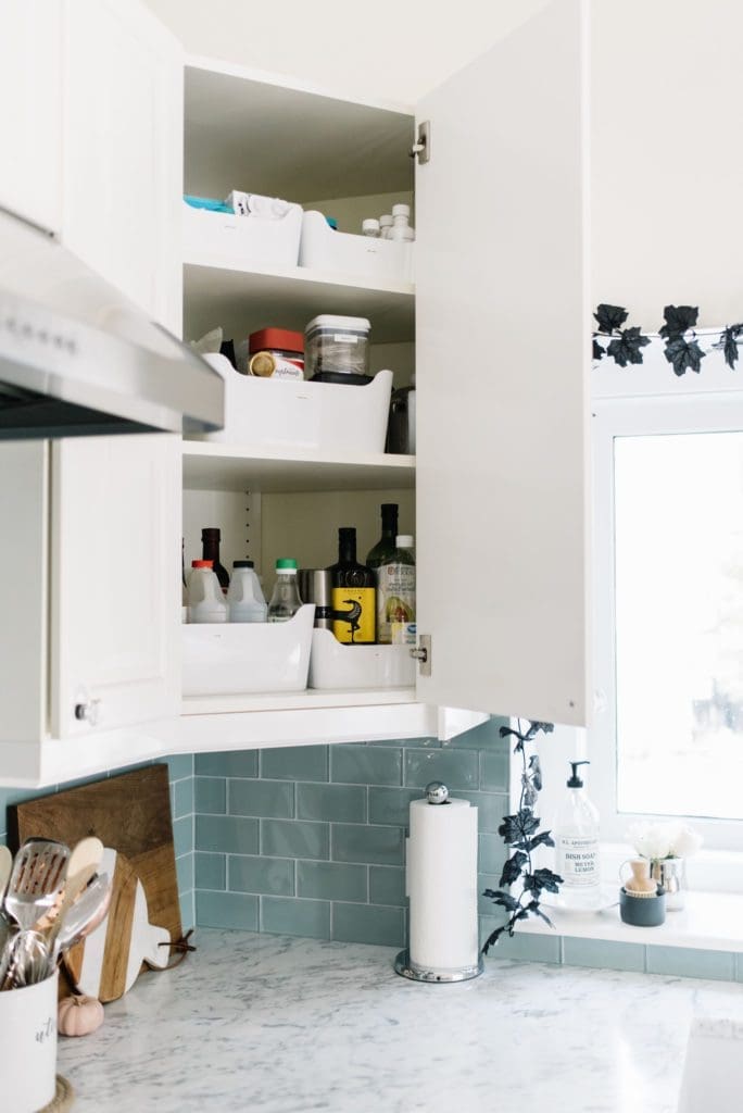 Labelled bins make storage easier in high kitchen cupboards