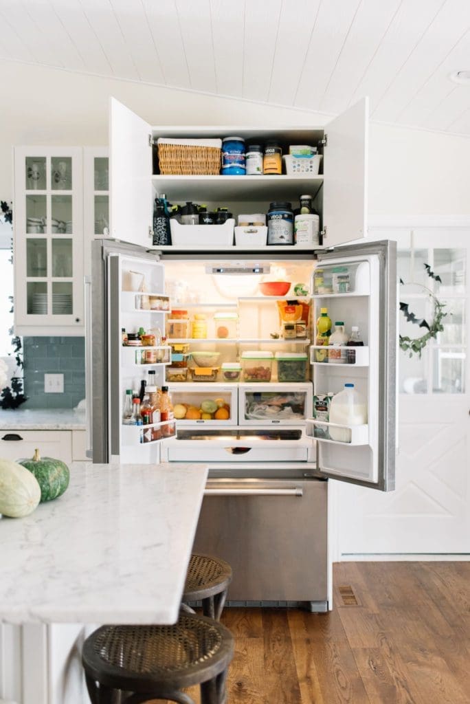 counter depth fridge open and full of food