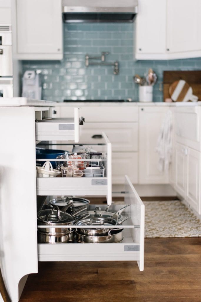 kitchen island drawers open and full of pots and pans