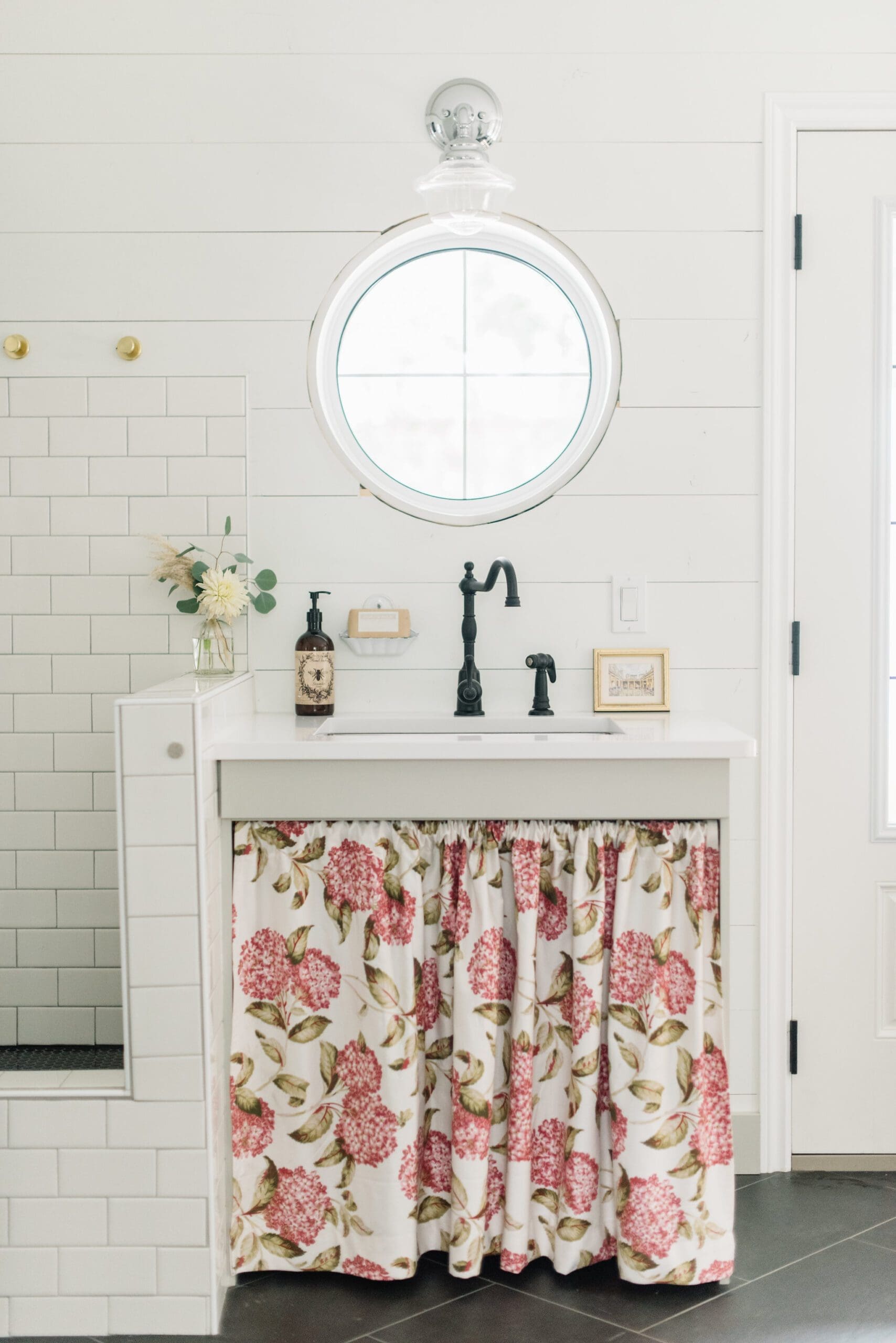 round window above sink in mudroom