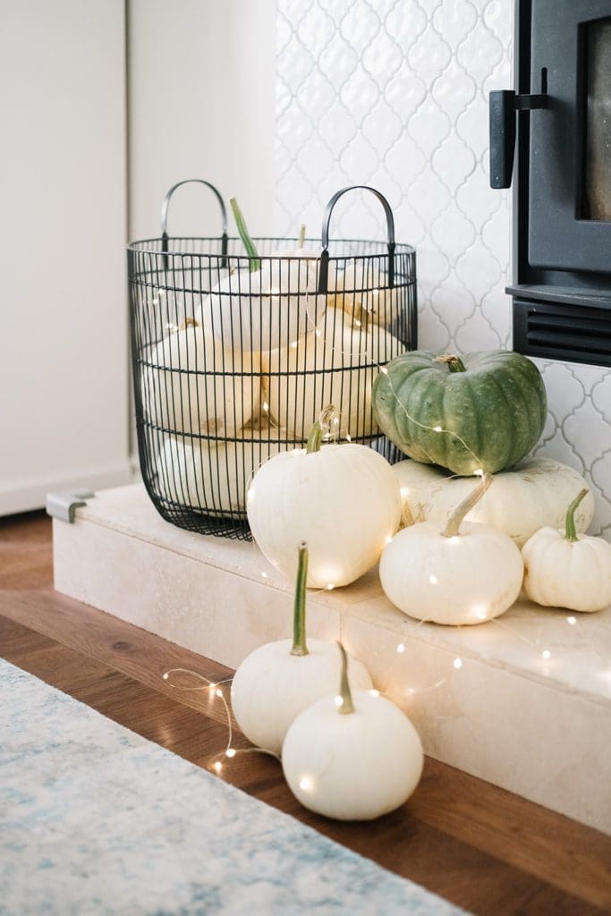 cascading pile of pumpkins with string lights