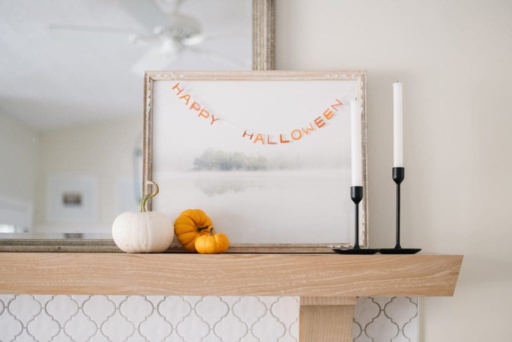 mini happy halloween banner strung across an art print
