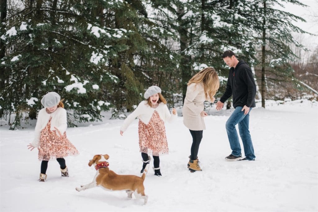 a family plays in the snow