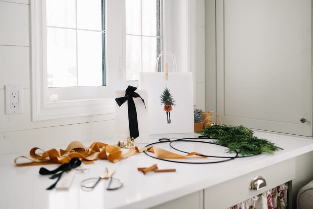 gift wrapping station with ribbons and bags