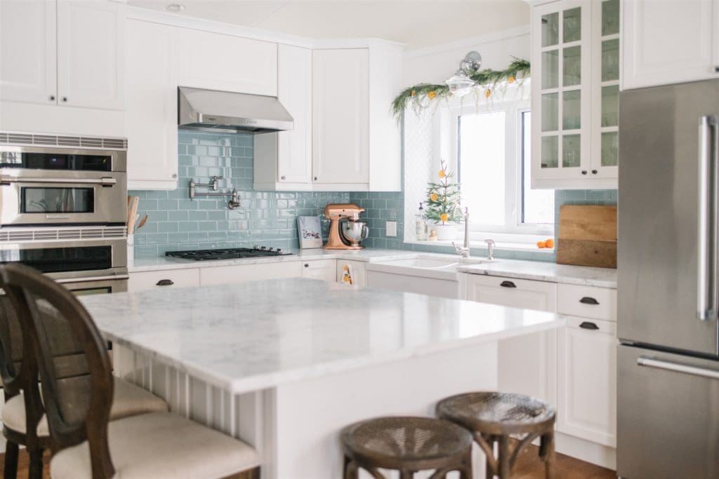 A kitchen with a large island iand farmhouse sink
