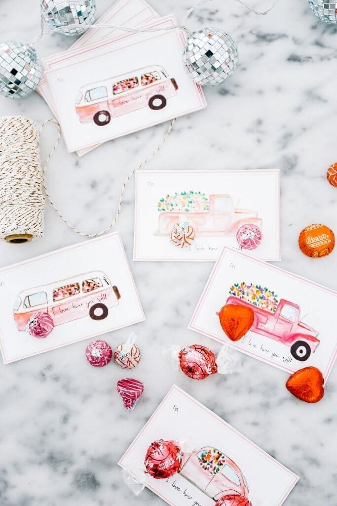 Valentine\'s day cards lying on marble counter with candies and string