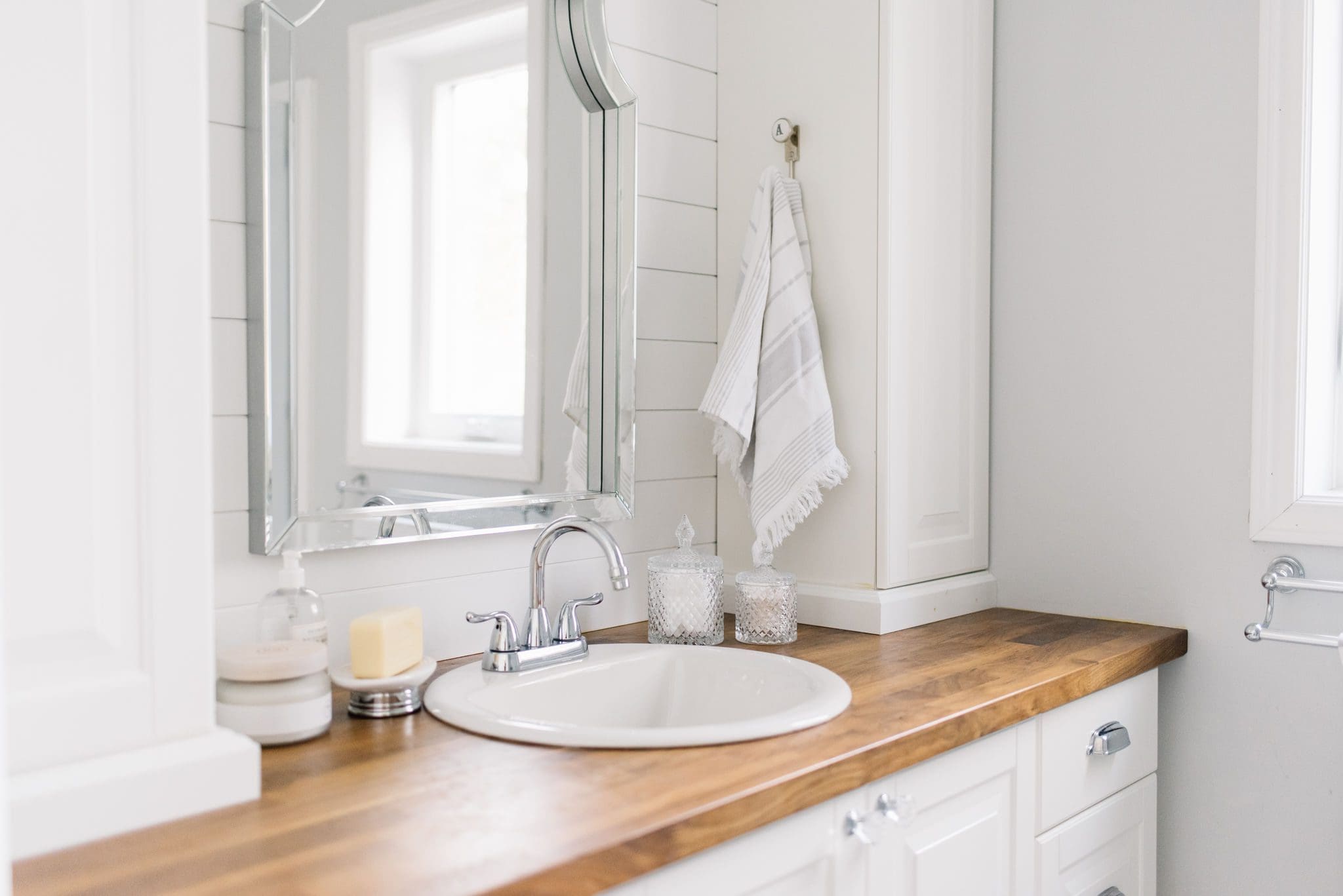 Tiny bathroom has built in storage towers and drawers