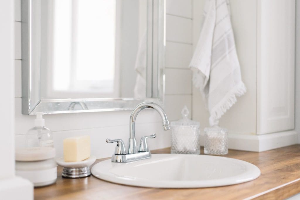 A small sink allows for extra counter space in a tiny master bathroom