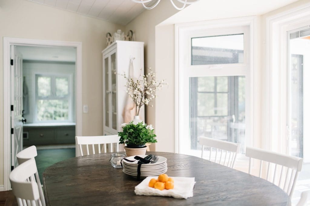 Dining Room table with stacked plates  and a plant