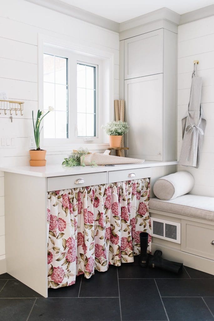Farmhouse mudroom with hidden storage