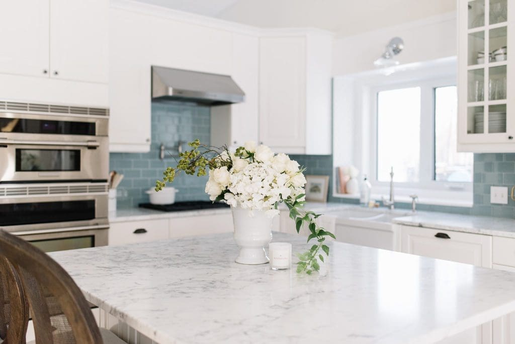white kitchen with marble countertops