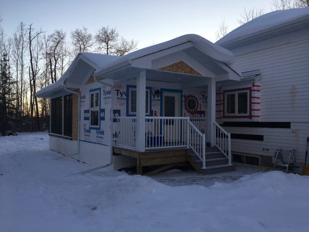partially finished mudroom addition covered in snow