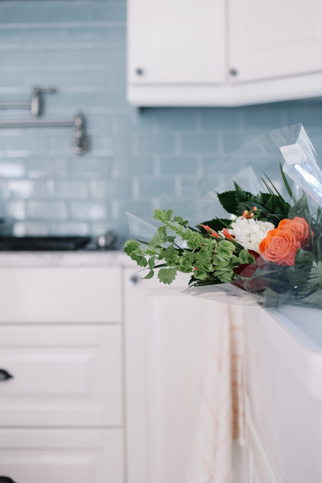 grocery store flowers sitting in the kitchen sink