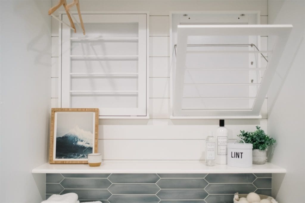 drying racks on the wall above a shelf