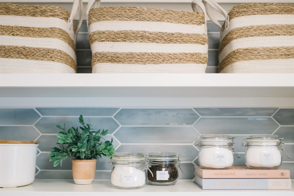 woven baskets on a shelf in a pantry