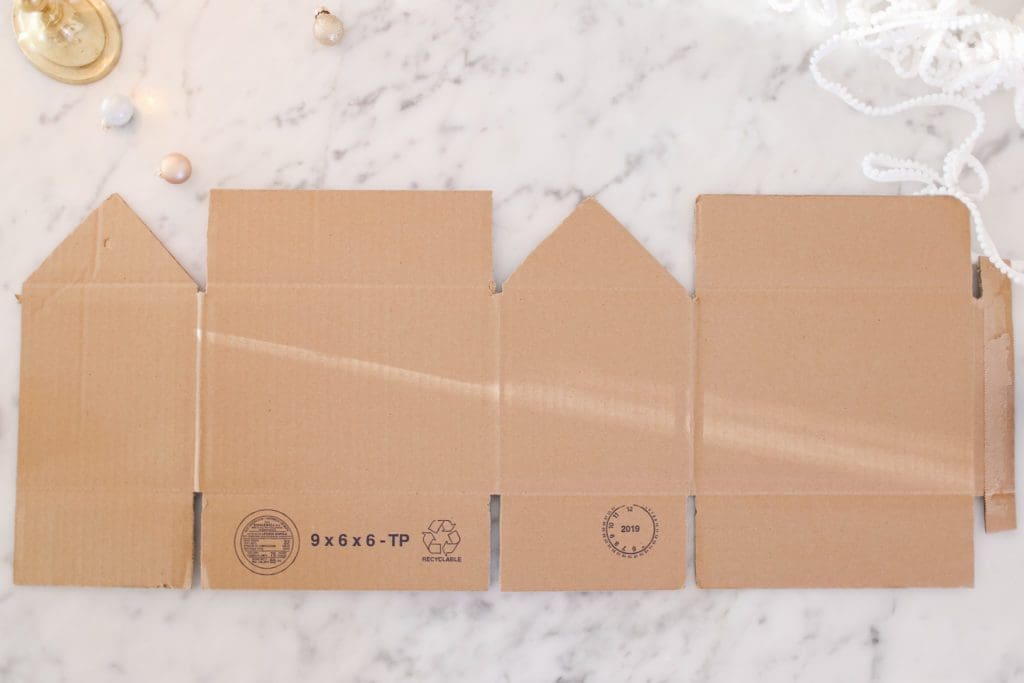 A close up of a box being cut to make a house