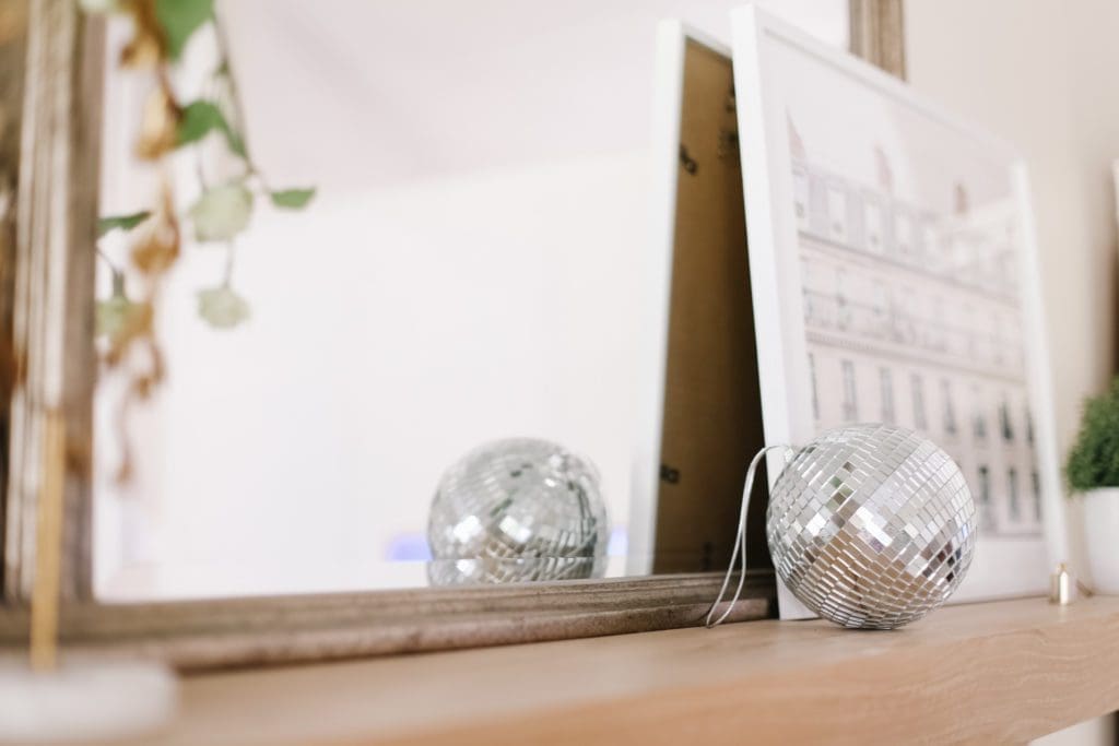 A small disco ball next to a mirror

