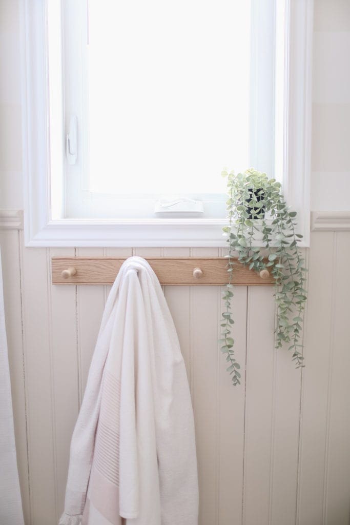 An oak peg rail with towel hanging on it
