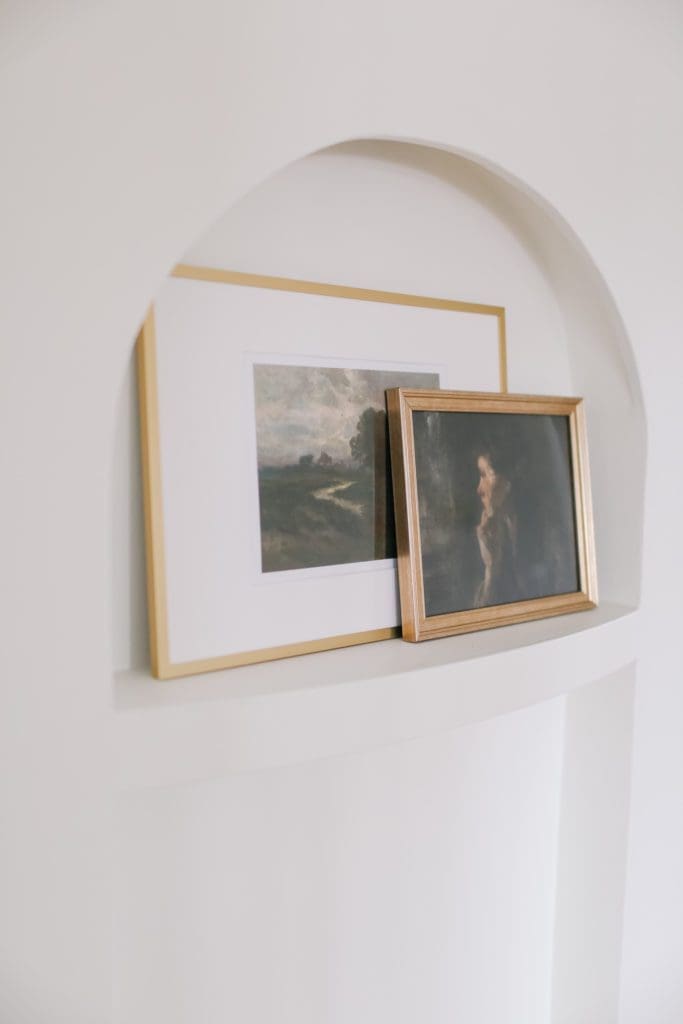 Gold framed prints in an art nook