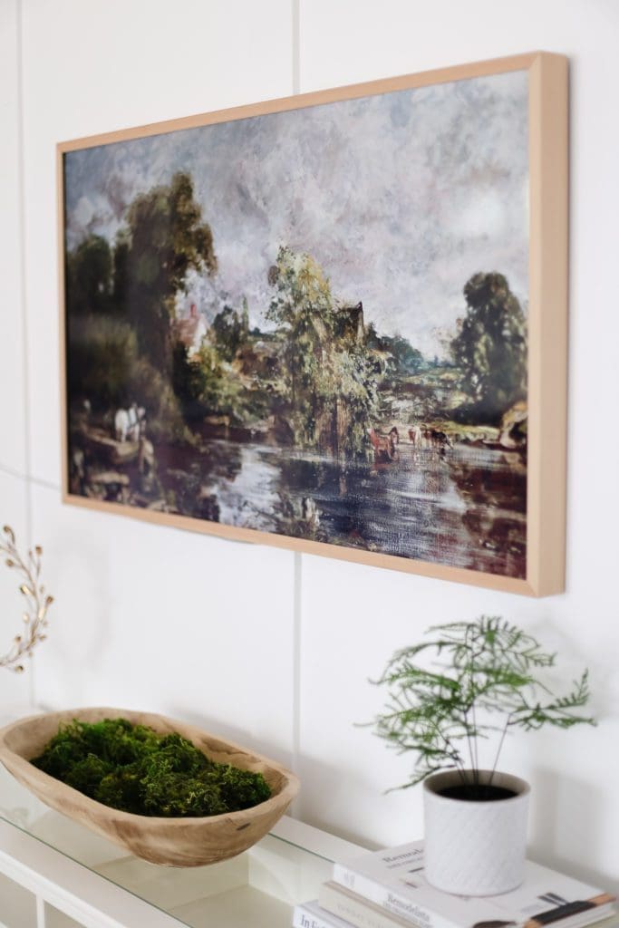 A TV with white oak frame and vintage painting displayed as digital art